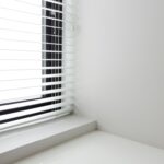 Home Bright minimalist interior with white window blinds and smooth wall, perfect for modern design.
